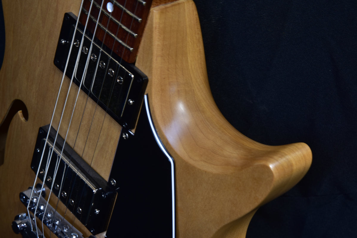 Lineage 6 semi-hollow electric guitar showing the sculpted upper horn, neck joint and dual humbuckers